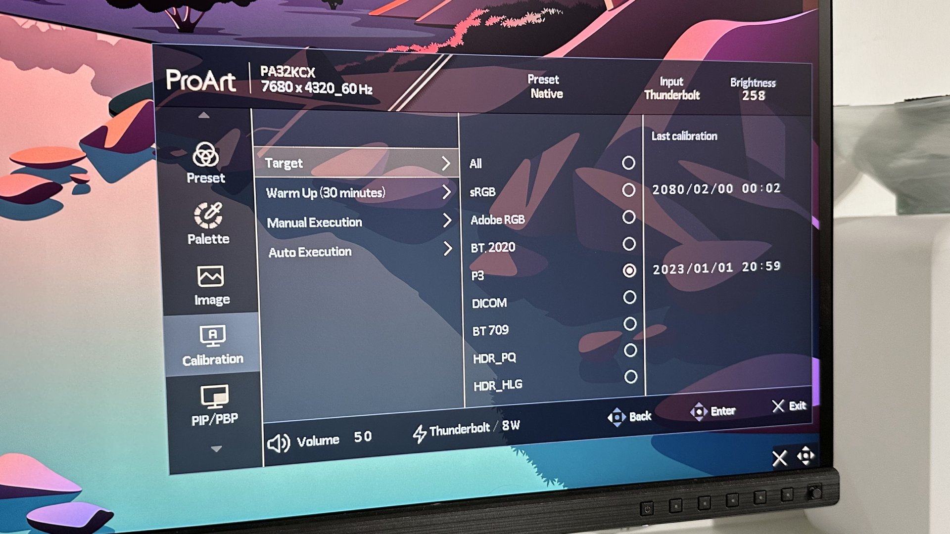 The Asus ProArt PA32KCX 8K monitor on a white desk in a home office during our review process